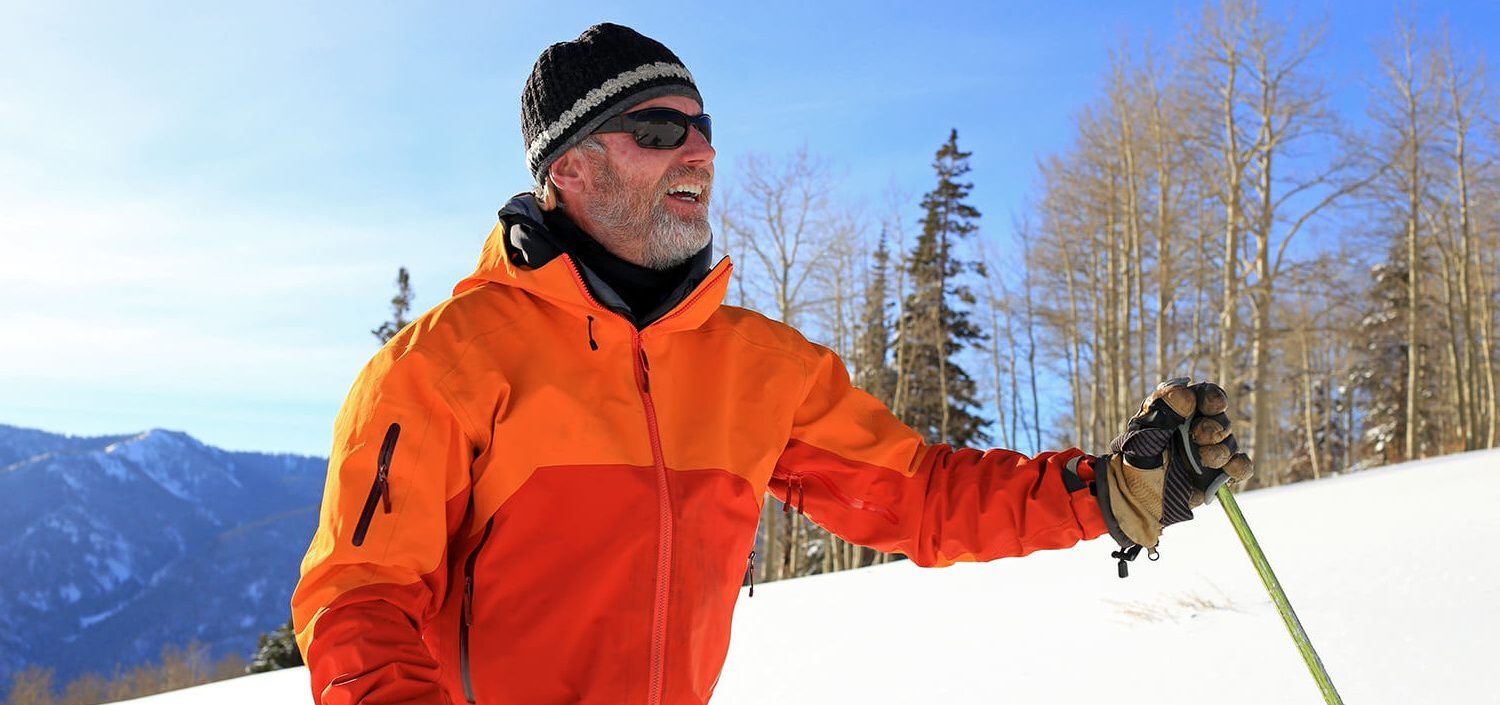 Man hiking in snowy Nordic mountains